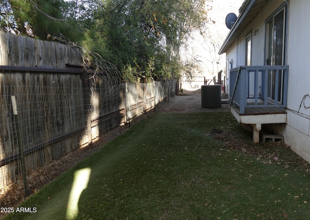 view of yard featuring a fenced backyard and central AC unit