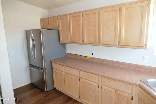 kitchen with freestanding refrigerator, dark wood-style flooring, and light brown cabinetry