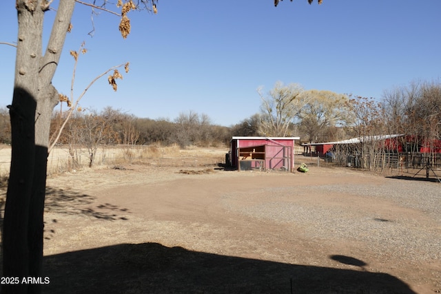 view of yard with an outdoor structure and fence