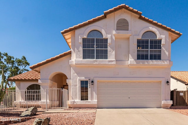 1202 E Libby St, Phoenix, AZ 85022 - mediterranean / spanish-style house with a tiled roof, stucco siding, and a garage