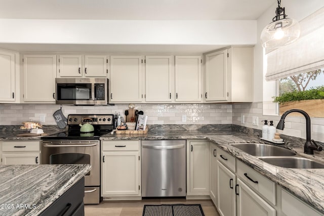 1202 E Libby St, Phoenix, AZ 85022 - kitchen featuring appliances with stainless steel finishes, a sink, light stone countertops, and decorative backsplash