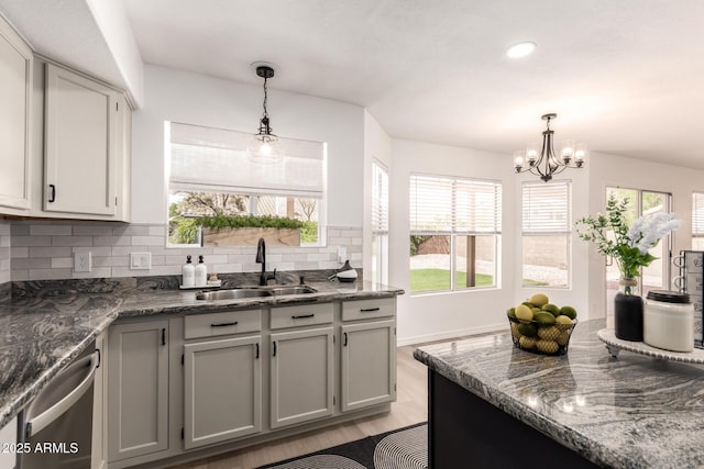 1202 E Libby St, Phoenix, AZ 85022 - kitchen featuring a sink, stainless steel dishwasher, tasteful backsplash, a chandelier, and light wood-style floors