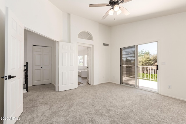 1202 E Libby St, Phoenix, AZ 85022 - unfurnished bedroom with access to exterior, light carpet, baseboards, connected bathroom, and a towering ceiling