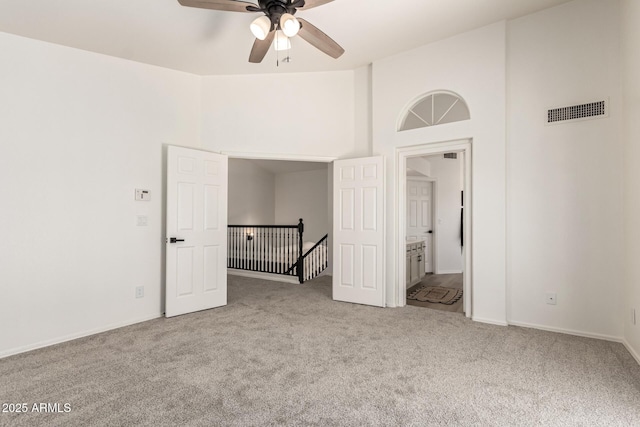 1202 E Libby St, Phoenix, AZ 85022 - spare room featuring carpet floors, a ceiling fan, a towering ceiling, and baseboards