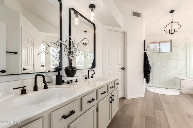 1202 E Libby St, Phoenix, AZ 85022 - bathroom with a marble finish shower, a chandelier, double vanity, and wood finished floors