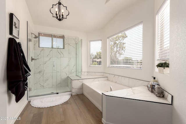 1202 E Libby St, Phoenix, AZ 85022 - bathroom featuring wood finished floors, a garden tub, a marble finish shower, and a chandelier