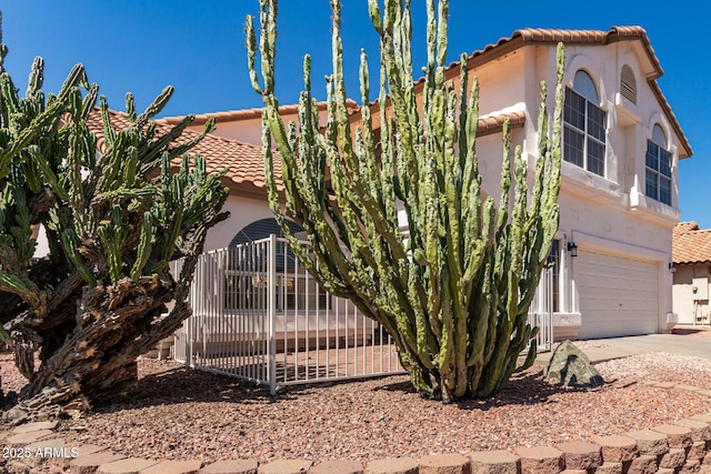 1202 E Libby St, Phoenix, AZ 85022 - view of front of home with a tiled roof, stucco siding, driveway, and a garage