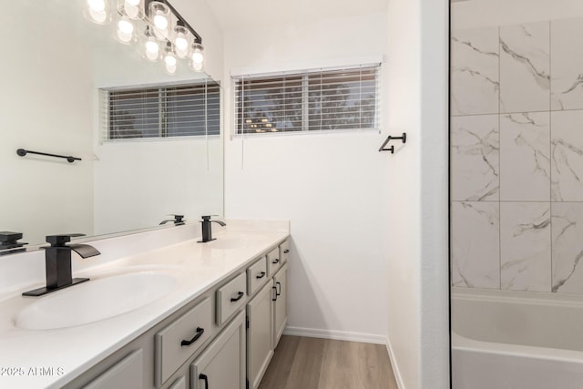1202 E Libby St, Phoenix, AZ 85022 - bathroom with double vanity, wood finished floors, shower / bath combination, and baseboards