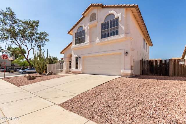 1202 E Libby St, Phoenix, AZ 85022 - view of front facade with an attached garage, driveway, a gate, and stucco siding