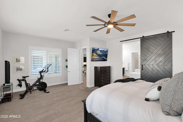 carpeted bedroom featuring ceiling fan and a barn door