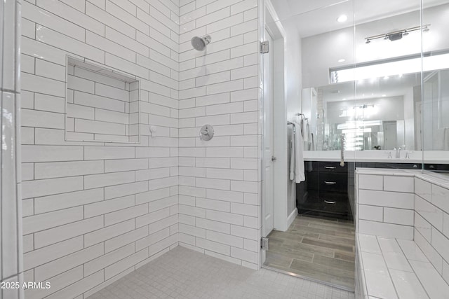 bathroom featuring vanity and tiled shower