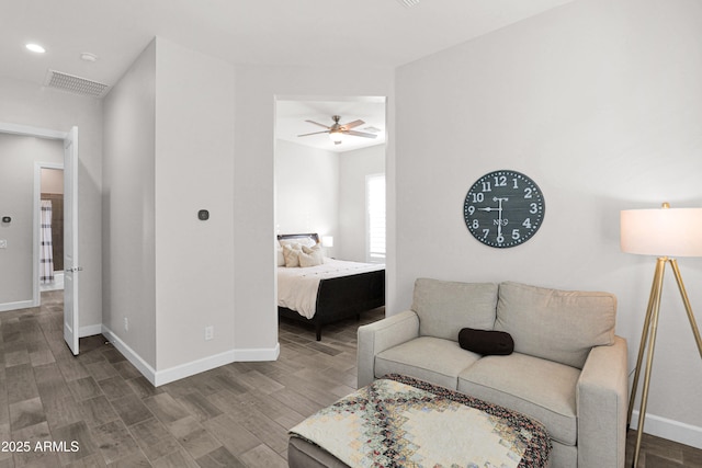 living room featuring ceiling fan and hardwood / wood-style floors