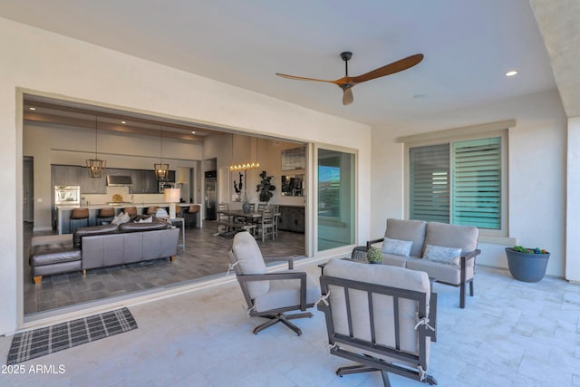 view of patio with an outdoor living space and ceiling fan