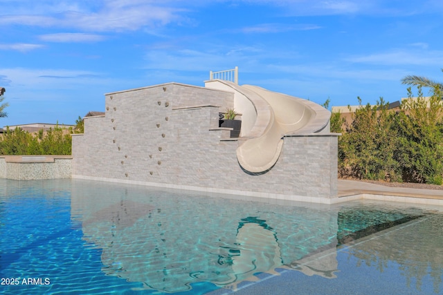 view of swimming pool featuring a water slide