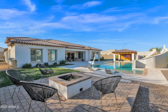 exterior space with a gazebo, a fire pit, and a patio