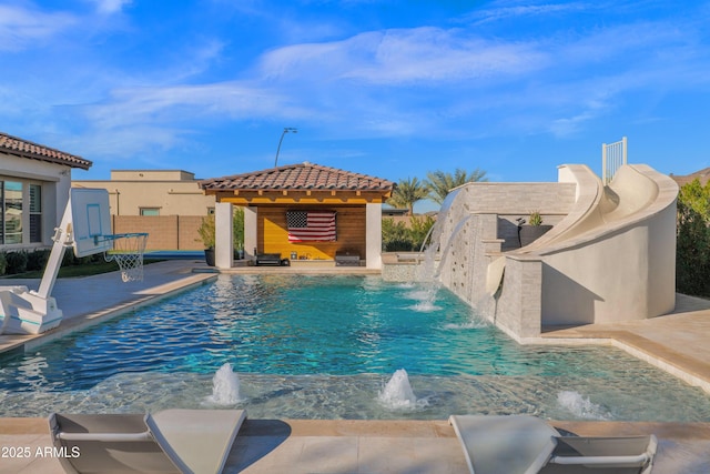 view of swimming pool with a patio, a gazebo, and pool water feature