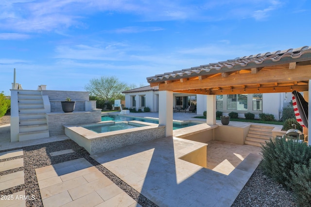 view of patio / terrace featuring a swimming pool with hot tub