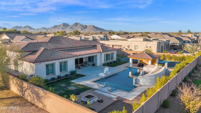 view of swimming pool featuring a mountain view, a patio area, and a gazebo