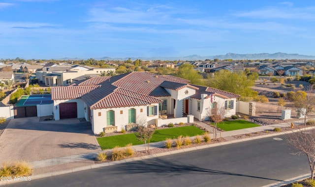 view of front of home with a mountain view and a garage