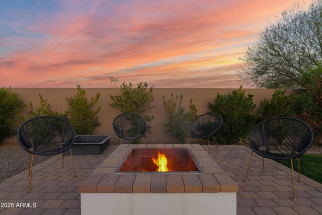 patio terrace at dusk with a fire pit