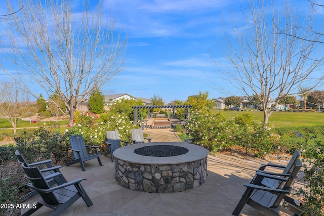 view of patio with a pergola and a fire pit