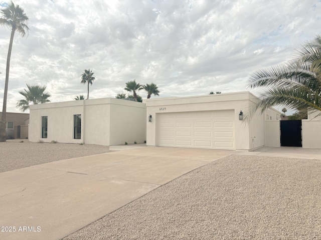 6529 E Eugie Ter, Scottsdale, AZ 85254 - view of front of house with stucco siding, driveway, and a garage