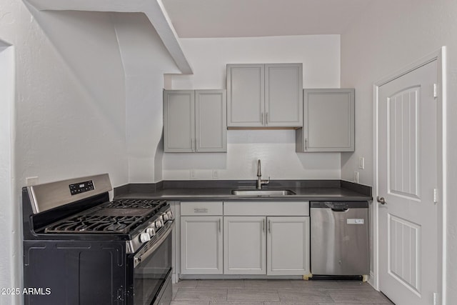 430 N 17th Ave, Phoenix, AZ 85007 - kitchen with appliances with stainless steel finishes, dark countertops, gray cabinetry, and wood finish floors