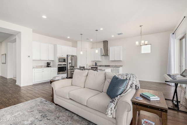 living room featuring visible vents, a notable chandelier, dark wood finished floors, recessed lighting, and baseboards