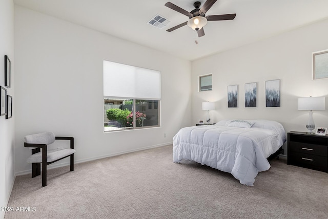 carpeted bedroom featuring a ceiling fan, baseboards, and visible vents