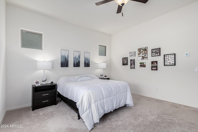 bedroom with light carpet, ceiling fan, and baseboards