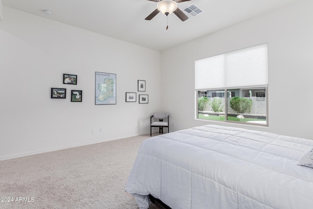 bedroom featuring visible vents, baseboards, ceiling fan, and carpet floors