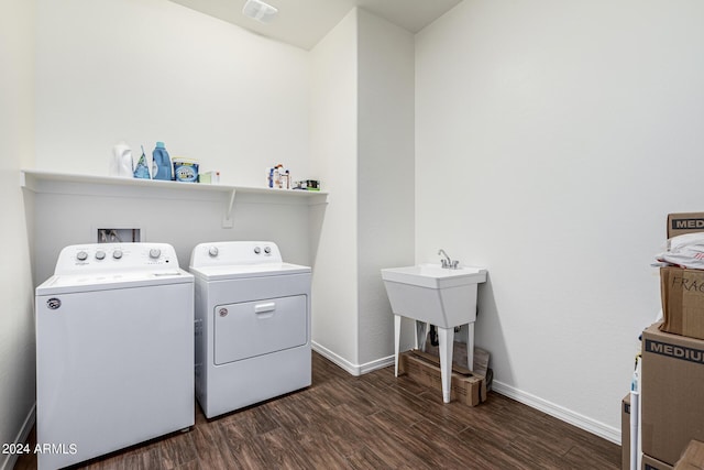 laundry room with visible vents, baseboards, dark wood finished floors, washing machine and dryer, and laundry area