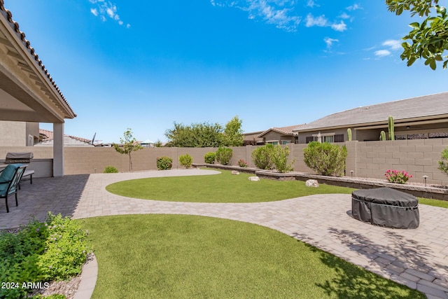 view of yard featuring a patio area, a fire pit, and a fenced backyard