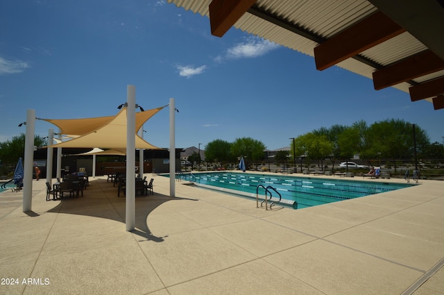 community pool featuring a patio area and fence