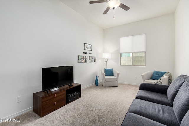 living area featuring baseboards, carpet, and a ceiling fan