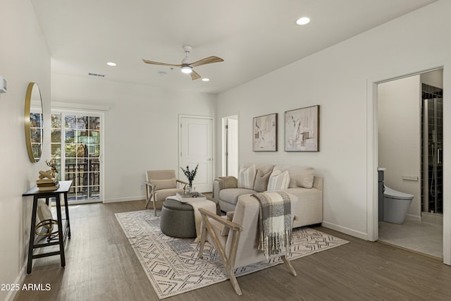 living room with ceiling fan and dark hardwood / wood-style floors