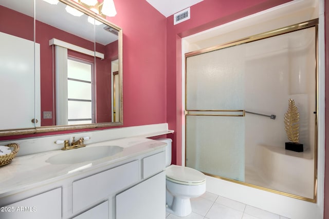 bathroom with tile patterned flooring, toilet, a shower stall, and vanity