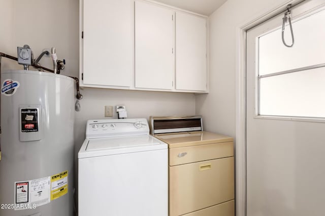 laundry room featuring washer / clothes dryer, electric water heater, and cabinet space