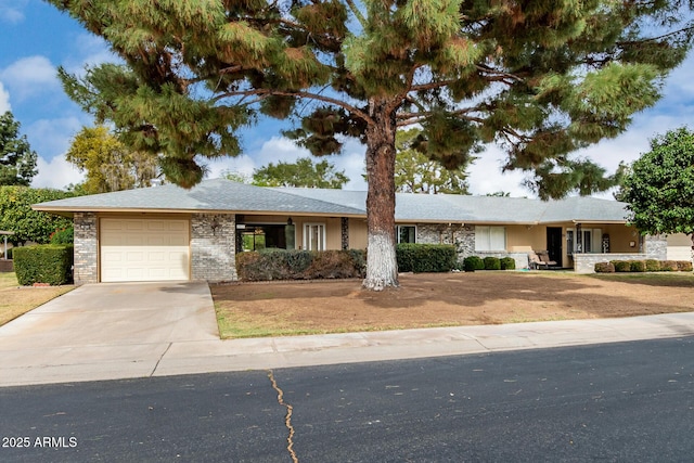 ranch-style home with driveway, an attached garage, and brick siding