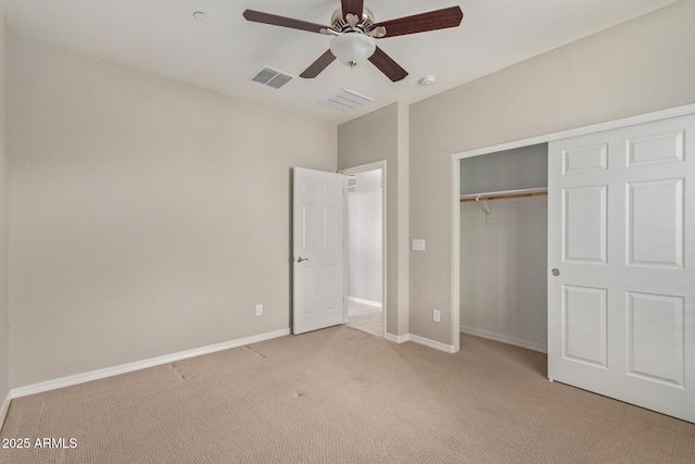 unfurnished bedroom with baseboards, visible vents, a ceiling fan, light colored carpet, and a closet