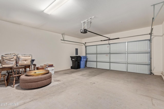 garage with baseboards and a garage door opener