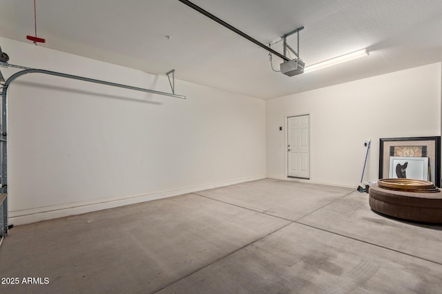 garage featuring baseboards and a garage door opener