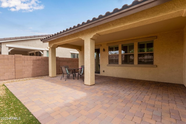 view of patio with fence and outdoor dining space