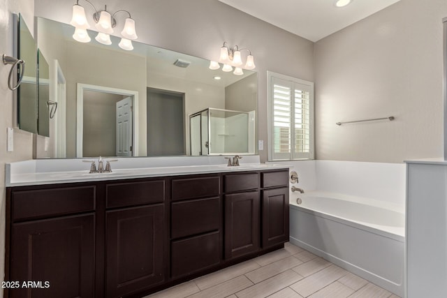 full bathroom featuring a stall shower, a garden tub, a sink, and double vanity