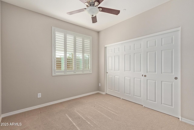 unfurnished bedroom with a closet, carpet flooring, and baseboards