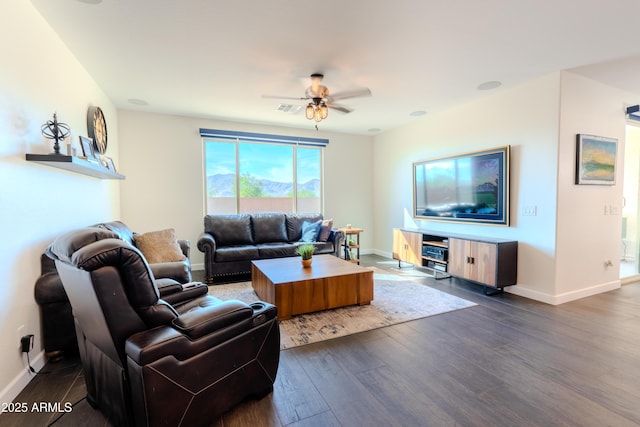 living room with ceiling fan and dark hardwood / wood-style flooring