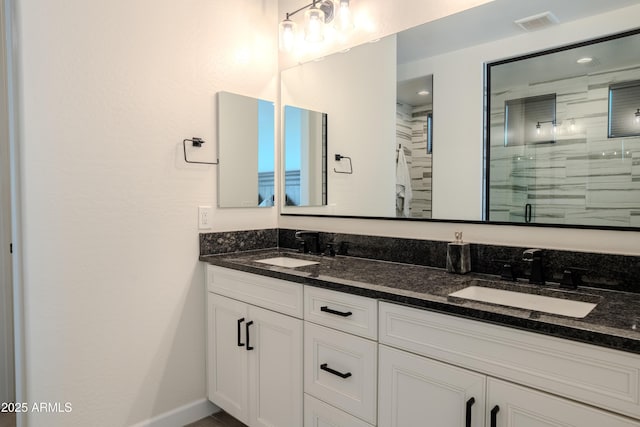 bathroom with vanity and a shower with shower door