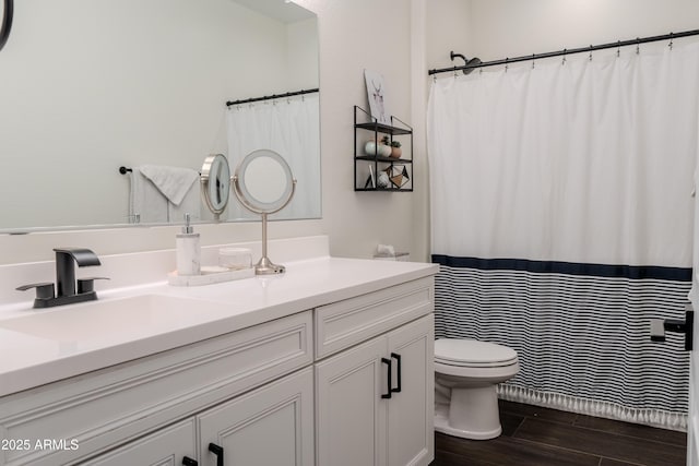 bathroom featuring vanity and toilet