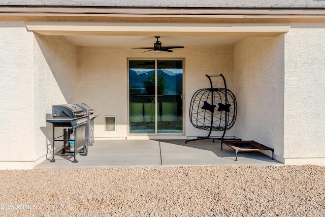 view of patio featuring a grill and ceiling fan