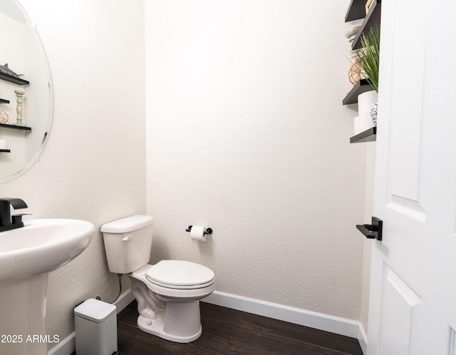 bathroom featuring sink, toilet, and hardwood / wood-style flooring